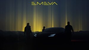 A group of people walking in front of a car Description automatically generated